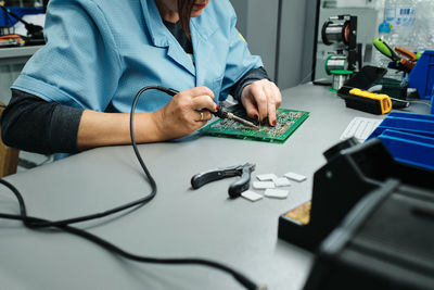 Midsection of woman working on table