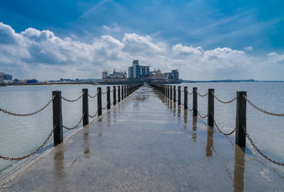 Pier over sea against sky