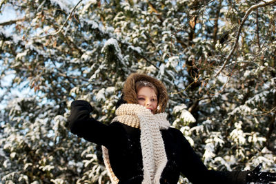 Portrait of smiling girl standing in snow