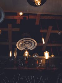 Illuminated tea light candles on table