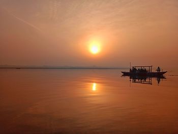 Scenic view of sea against orange sky during sunset