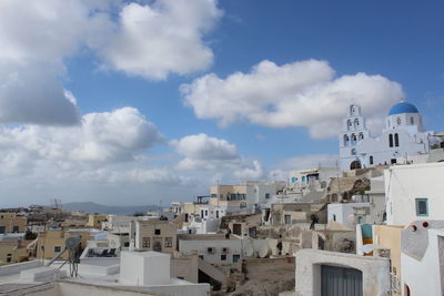 Buildings in town against sky