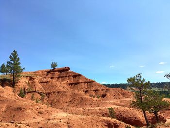 Scenic view of landscape against blue sky