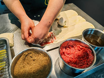 Cropped hands of person preparing food