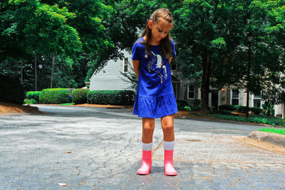 Full length of girl standing on road