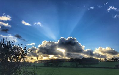 Scenic view of landscape against cloudy sky