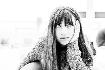 Close-up portrait of a young woman looking away