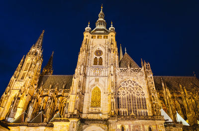 Low angle view of illuminated building against sky at night