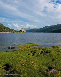 Scenic view of lake against cloudy sky