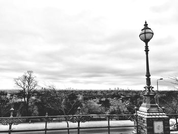 Street light against cloudy sky