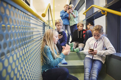 Junior high students using smart phones in school