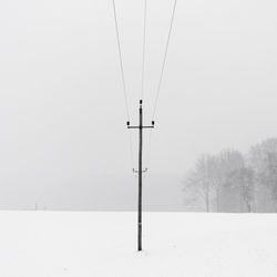 Snow covered field against sky