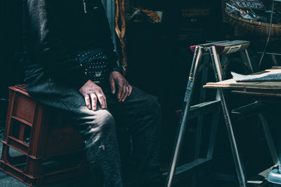 Low section of man sitting on chair