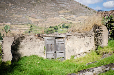 House on mountain against sky