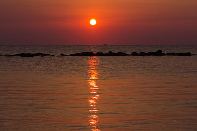 Scenic view of sea against romantic sky at sunset