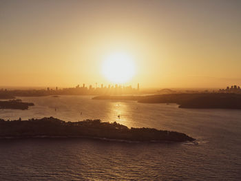 Drone view of sydney harbour with the cbd skyline in the background. south head in the foreground.