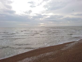 Scenic view of beach against sky during sunset