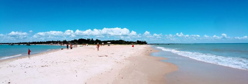 Panoramic view of beach against blue sky