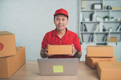 Portrait of woman holding box