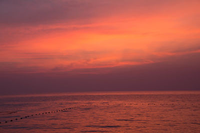 Scenic view of sea against romantic sky during sunset