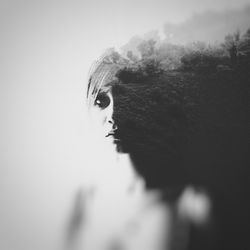 Close-up of woman looking away against sky