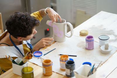 Art occupation, young woman study ceramics after work to start small business with pottery studio