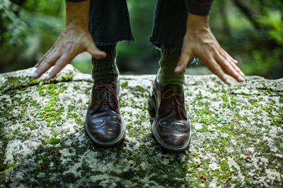 Low section of man standing by plants