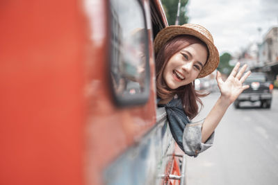 Young woman using phone while standing in city