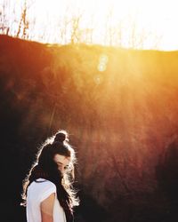 Low angle view of girl standing against mountain