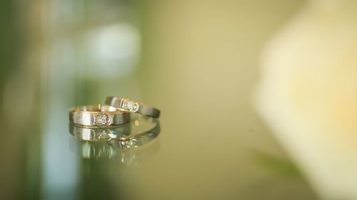 Close-up of wedding rings on table