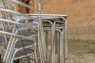 Close-up of empty chairs against wall