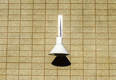 Close-up of lamp against wall