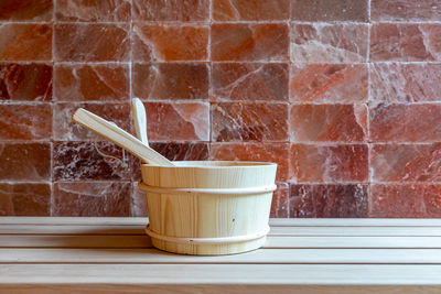 Close-up of drink on table against brick wall