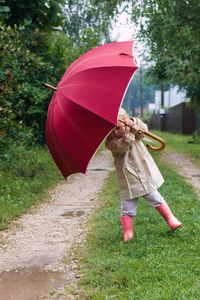 Woman with umbrella walking on rainy day