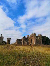 Old ruin on field against sky