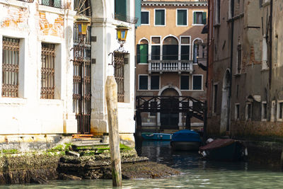 Buildings by canal in city