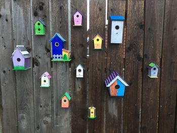 Close-up of padlocks hanging on wooden wall