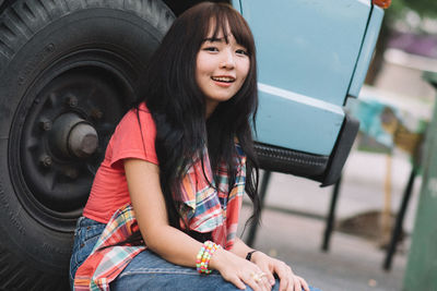 Portrait of young woman sitting in car