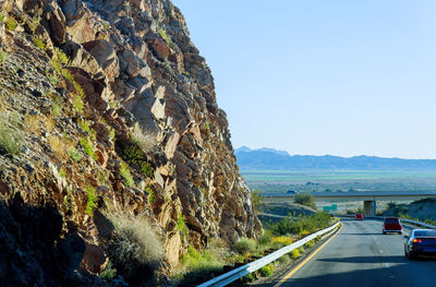 Road amidst rocks against clear sky