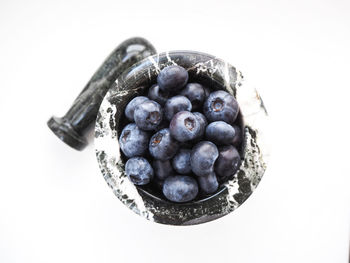High angle view of berries over white background