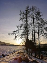 Scenic view of snow covered land against sky during sunset