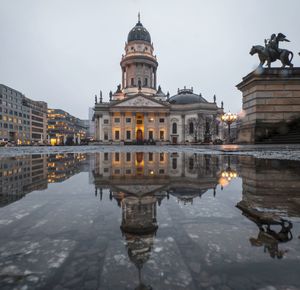 Reflection of buildings in puddle