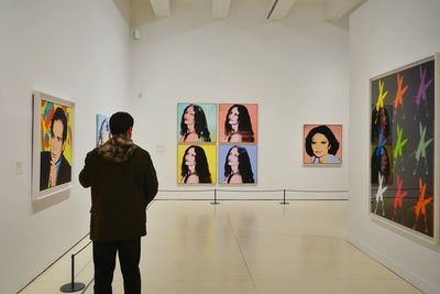 Man standing against wall in museum
