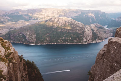 High view of boat cruising through fjords in norway