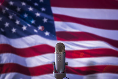 Close-up of flags against blue wall