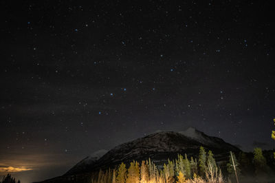 Scenic view of mountains against sky at night