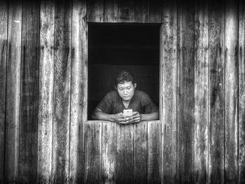 Portrait of woman sitting on wooden floor