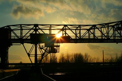 Silhouette of bridge against sunset sky