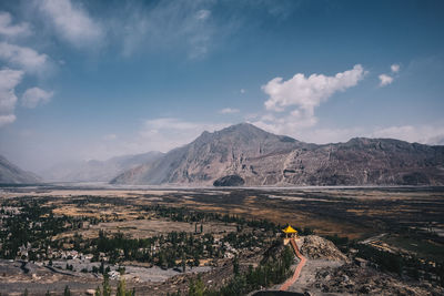 Landscape against mountains