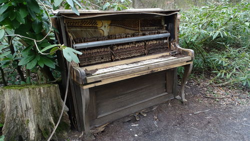 Old abandoned piano on land